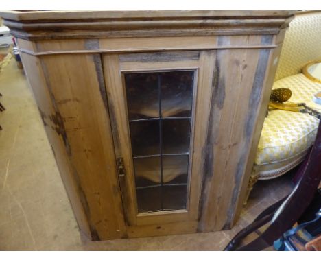 A Vintage Pine Astral Glaze Corner Cupboard, the cabinet having two scallop shaped shelves, approx 94 x 56 x 42 cms.