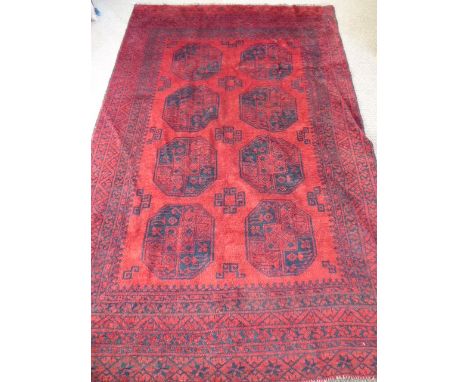 An Afghan Ersari Turkmen carpet, in claret and blue design with eight central guls, approx 270 x 180 cms.