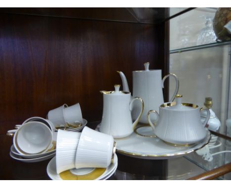 A Russian Porcelain Tea Set, comprising six cups and saucers, creamer, sugar bowl, coffee pot and sandwich plate together wit