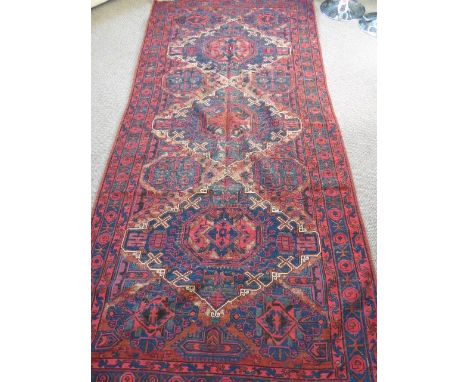 An Antique Caucasian Soumak Carpet, with diamond shaped central ghouls in dark pink and blue with geometric borders, approx 3