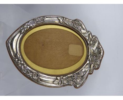 A Silver Art Nouveau Oval Picture Frame, with an oak easel back, Birmingham hallmark, dated 1904, approx 23 x 31 cms together