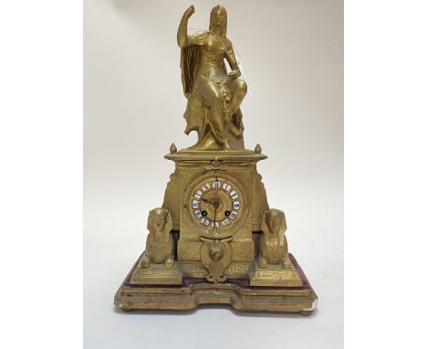 A French Egyptian revival mantel clock, second half of the 19th century, the gilt case of architectural form with figural sur