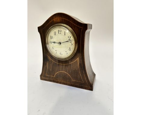 An Edwardian mahogany arched mantel clock with box wood strung and inlaid front with enamelled dial and Arabic numerals, with