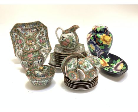 A Chinese Canton Famille verte tea set, comprised three serving plates, six side plates, six cups and saucers, milk jug, suga