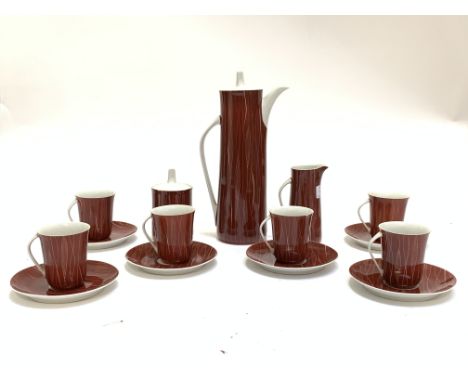 A Retro Coffee Set 'Cmieilow Made In Poland' comprising six cups and saucers, sugar basin, coffee pot and milk jug, red groun