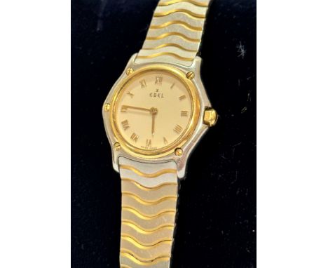 A lady's Swiss Ebel wristwatch Quartz Wave the champagne dial with Roman numerals and 18ct gold bezel on stainless steel case