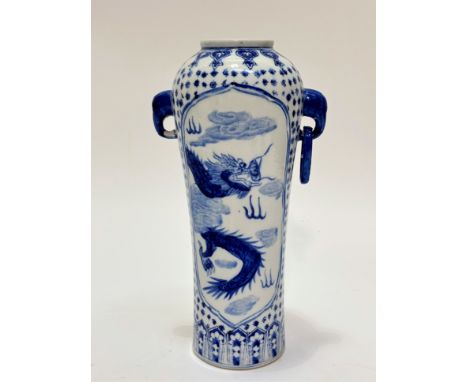 A Chinese porcelain blue and white decorated cylinder tapered vase decorated with relief dragon design, chasing the pearl of 