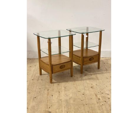 Ercol, A pair of blonde elm bedside tables, each with glass top over adjustable glass shelf and drawer to base, H65cm, W49cm,