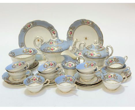 A 19thc china twenty eight piece tea service including two cake plates, teapot (with hairline crack) a two handled sugar basi