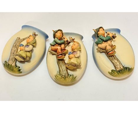 A group of three Hummel pottery figure oval wall pockets with Apple Tree boy and girl figures, (15.5cm x 11cm)