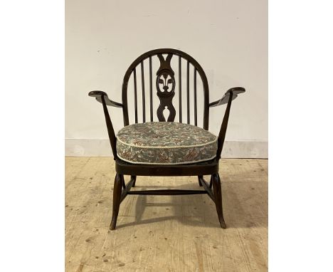 Ercol, a stained elm and beech lounge chair, with hoop, spindle and splat back over upholstered seat cushion, raised on turne