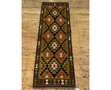 A Chobi kilim runner fur of typical geometric design, 200cm x 65cm