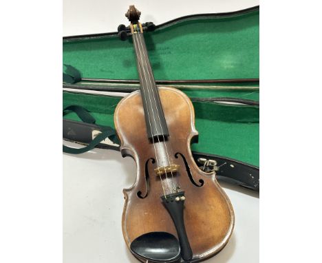 An Italian Magini two piece violin with paper label D E U T I C H E U R B E I T, spilt at back and restoration to body and fi