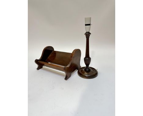 An oak scroll end book trough raised on bracket feet, (17cm x 30cm x 20cm) and an oak relief carved column table lamp with ba