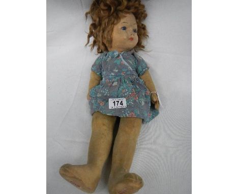 An early 20th century Chad Valley 'Bambina' doll with glass eyes and original button on right side of body, approximately 46 