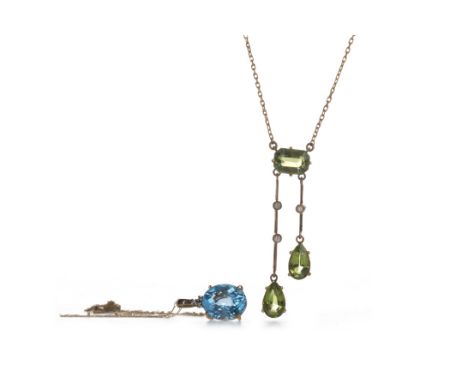GREEN GEM SET NECKLACE, the central step cut green gem with two asymmetric suspended sections each set with a pear shaped gre