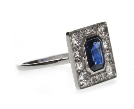 SAPPHIRE AND DIAMOND RING, set with a central step cut sapphire of approximately 1.15 carats, within a border of round brilli