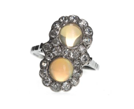 OPAL AND DIAMOND RING, set with two cabochon opals within a border of old cut diamonds, the diamonds totalling approximately 