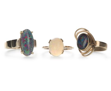 OPAL RING, set with a cabochon opal 11mm long, in nine carat gold, size P, along with two opal doublet rings marked 9CT, size