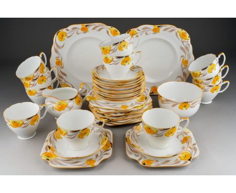 An Art Deco style Grafton china tea set pattern no 5558 decorated with yellow flowers (buttercups) comprising 11 cups, 12 sau