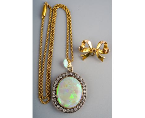 An antique opal cluster pendant with chain and antique 9ct gold bow brooch. Set with an oval opal cabochon, surrounded by col