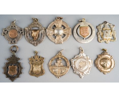 A collection of ten silver, silver plated and chrome plated medallions, some of Celtic design / Irish origin, four hallmarked