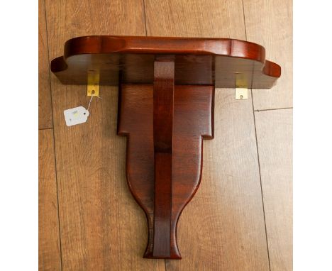 A modern mahogany wall bracket, the top inlaid with two brass lozenges, height 35cm x width 41cm