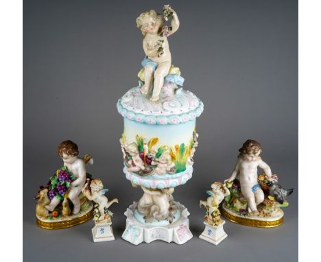A late 19th century Capodimonte style relief moulded and figural urn and cover, s.d., height 40cm, together with a small pair