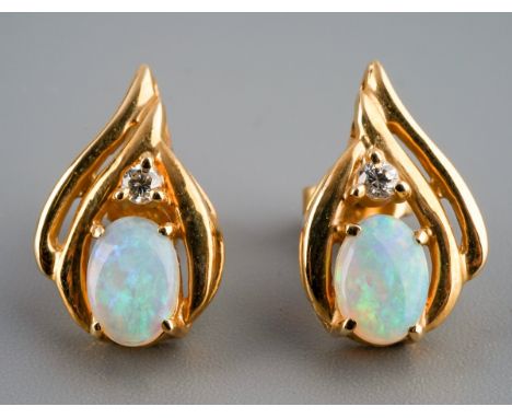 A pair of 14c gold opal and diamond set earrings. Gross weight 3.4g