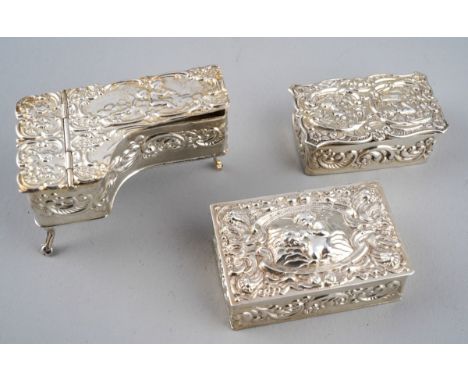 A Queen Elizabeth II silver ornate dressing table box, the cover chased with putti, hallmarked by S J Rose, Birmingham, 1977 
