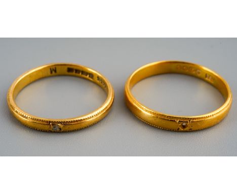 Two 22 ct gold wedding bands, one set with a ruby chip, gross weight 5.4g