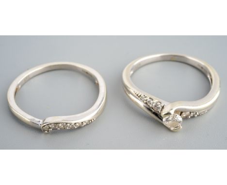 A 9ct white gold engagement ring and a 9ct white gold fitted diamond set wedding ring. Both rings hallmarked 9ct gold London,