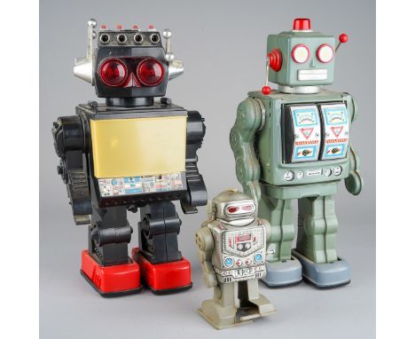 Three Robot toys, comprising a black plastic robot with red feet, made in China, clean battery compartment, untested, height 