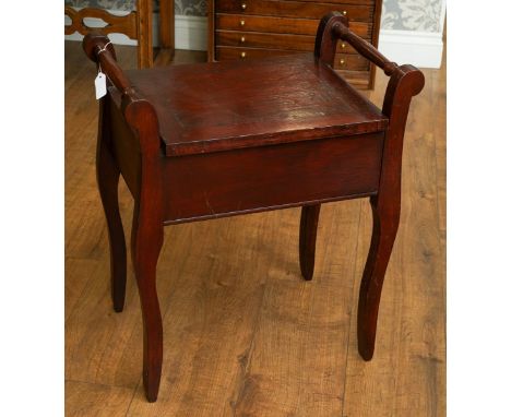 A mahogany stained piano stool with hinged seat, on shaped legs