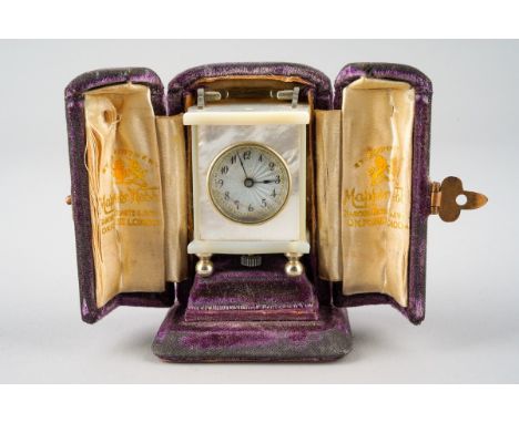 An early 20th Century mother-of-peart mounted miniature cased carriage clock, the silvered dial with Arabic numerals., white 