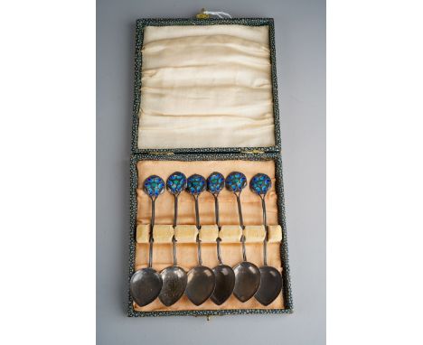 Liberty &amp; Co: a matched set of six Arts &amp; Crafts silver and enamel tea / grapefruit spoons, with lily leaf motif term