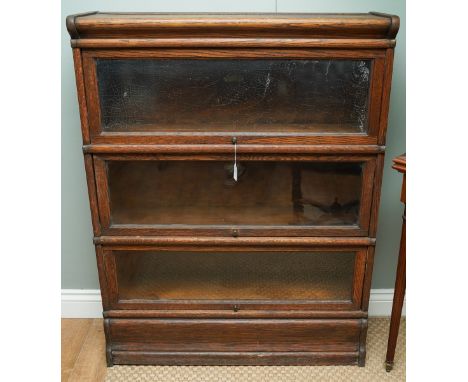 An early 20th century Globe Wernicke three section oak bookcase, name plaques to all shelves, the top glazed panel applied wi