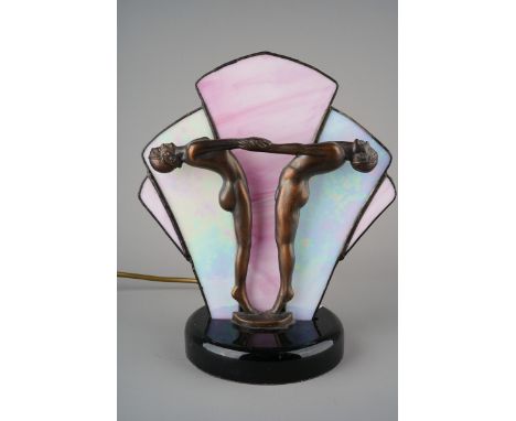 An Art Deco bronzed metal lamp modelled as a female and male dancers, pink graduating lined shade to reverse, on ebonised sta