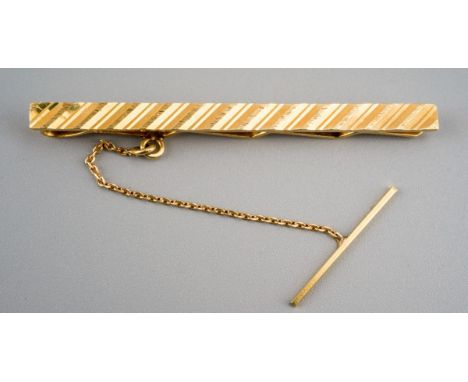 A tie pin. Stamped 585, approx length 50mms, gross weight 3.97 grams.