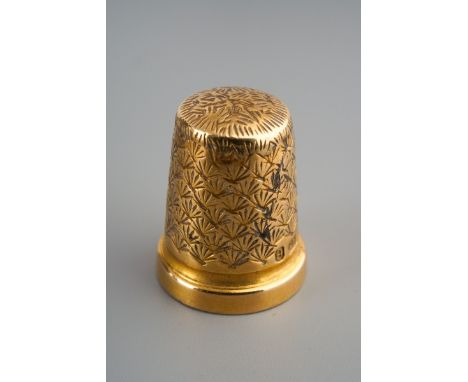 An Edwardian 15ct gold thimble. The thimble with engraved decoration, hallmarked by Charles Horner, Birmingham, 1901, approx 