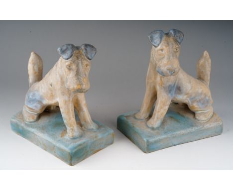 A pair of Art Deco Bourne Denby Danesy Ware book ends modelled as Fox Terriers, blue accents to glaze, stamped to undersides,