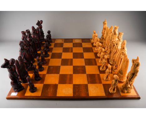 A large Westminster stained wood chessboard with 32 resin figural novelty large chess pieces (minor chips to some pieces), th