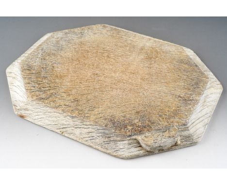 A figured oak chopping board or kettle stand, octagonal form with moulded edge carved with mouse signature by the workshop of