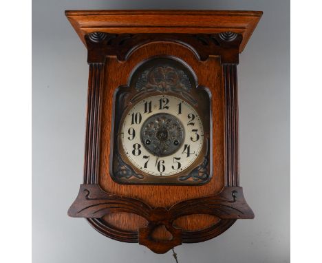 An oak cased large mantle clock, brass dial applied with butterfly motif and scrolls, Arabic numerals (untested - dial upside