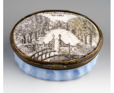 An 18th Century Staffordshire enamel snuff box and cover, crimped blue base, the cover transfer printed with view of Cheltenh