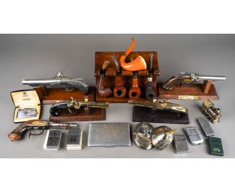 A box of smoking ephemera items, including a heavy wooden pipe stand and pipes, assorted table lighters in the form of pistol