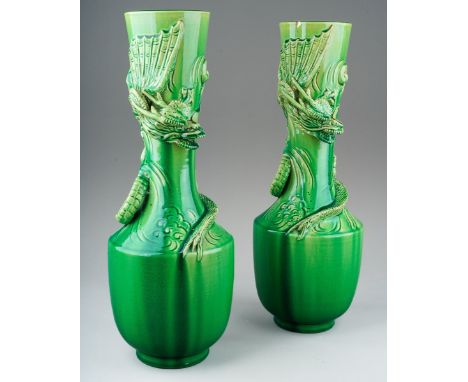 A pair of Japanese Meiji period Awaji dragon vases of baluster form, green glazed and decorated in high relief, s.d., height 