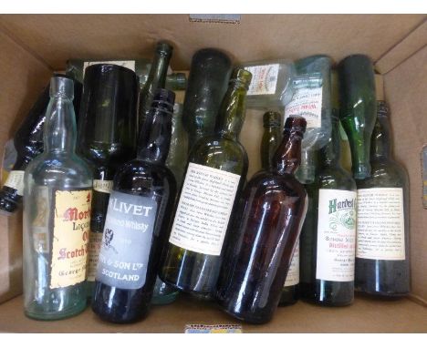 A box of glass scotch whisky and other bottles.