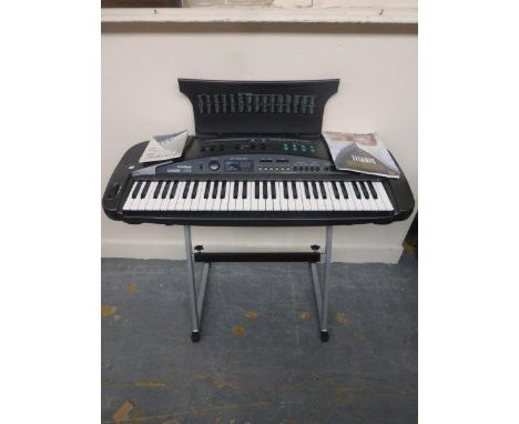 A Casio Tone Bank CT-X1 electronic keyboard and stand.