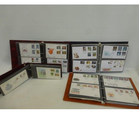 Four assorted First Day cover albums of various ages.